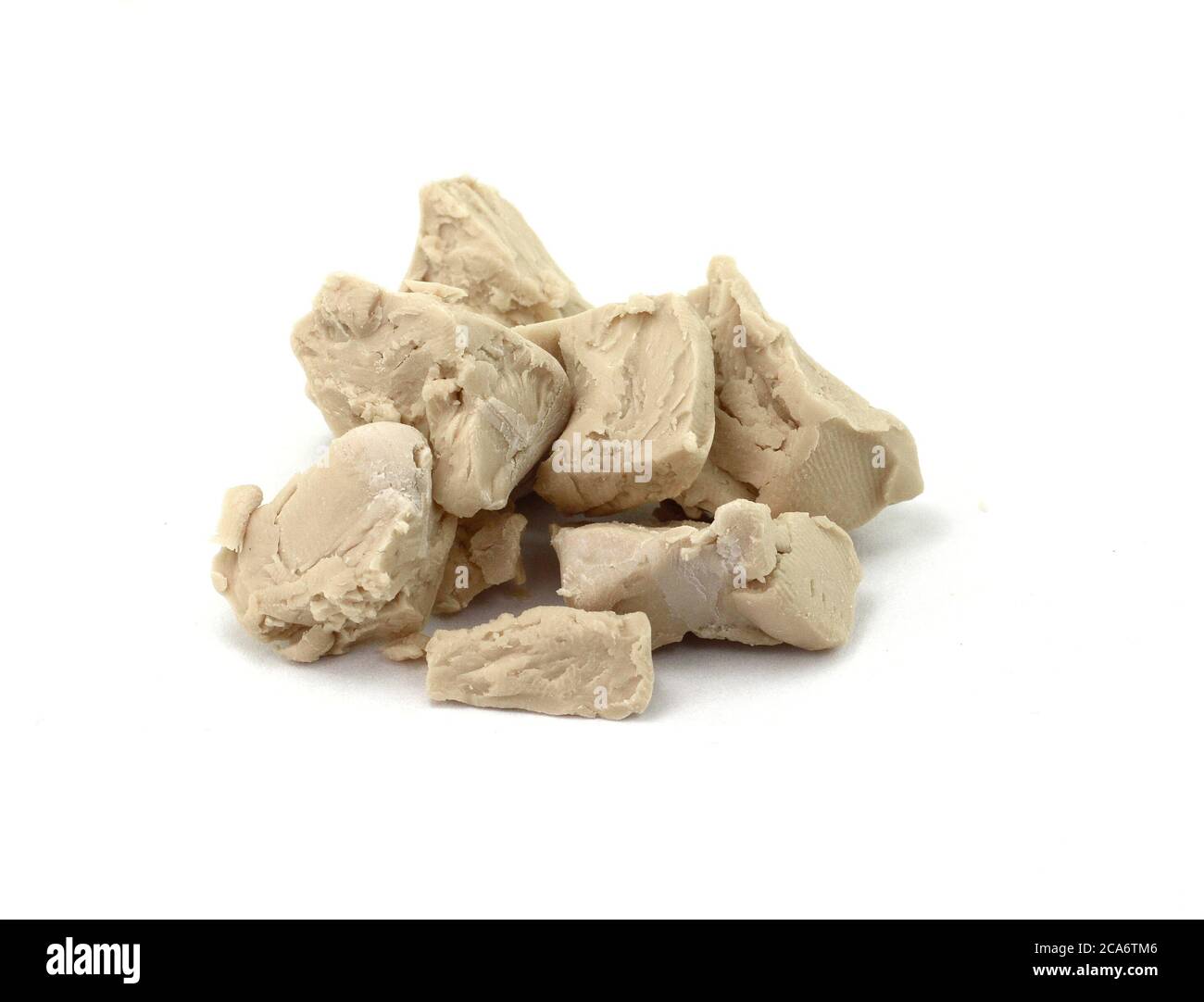 Baker's yeast isolated on white background. A block of compressed fresh