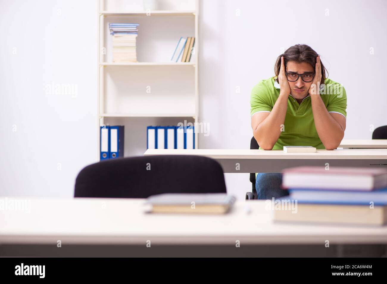 Young male student in the classroom studying Stock Photo - Alamy