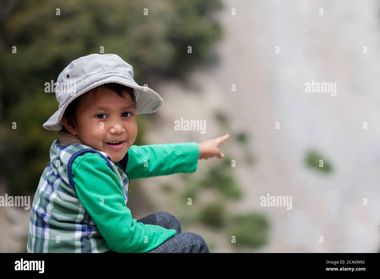 Young latino boy in awe after spotting elusive wildlife in Southern California mountains. Stock Photo