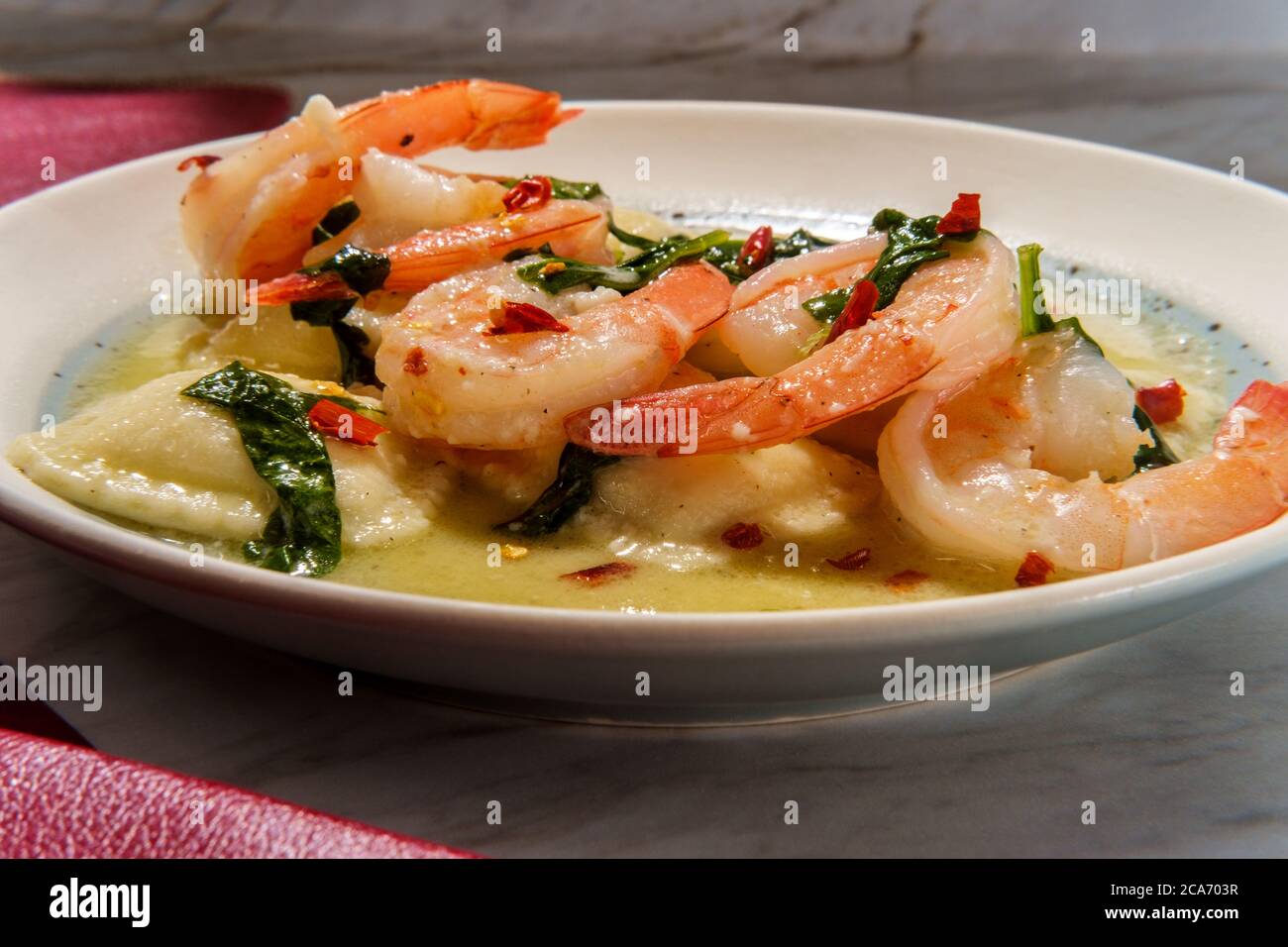 Tuscan creamy shrimp and cheese ravioli with spinach Stock Photo Alamy