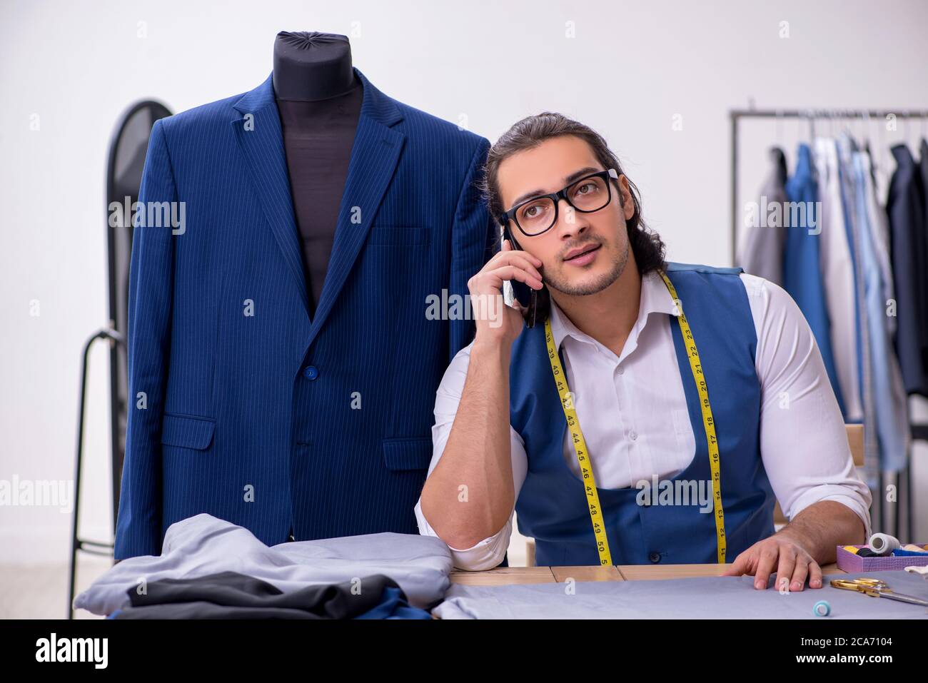 Young tailor working at workshop Stock Photo