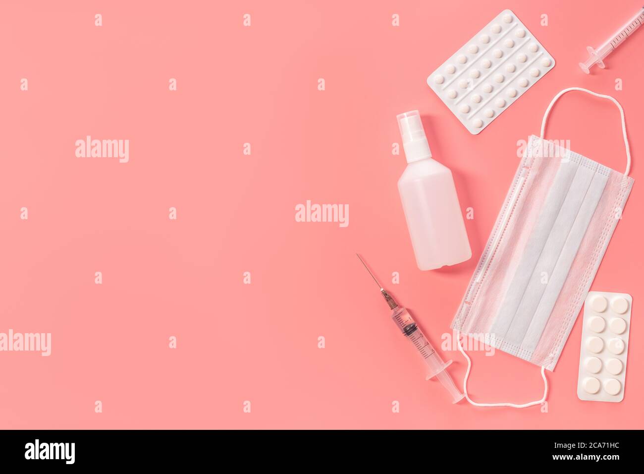 A set of various medical items. Syringe, mask, tablets and sanitizer on ...