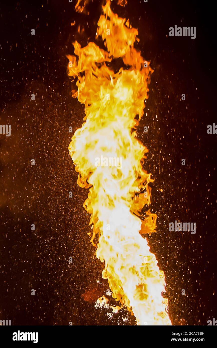 Senno, Belarus - 07.03.2015: Fire show. Artists exhale flame, pillar of fire on a black background. Stock Photo