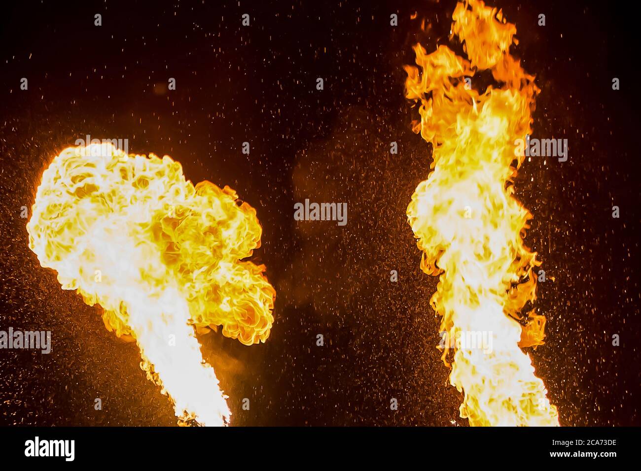 Senno, Belarus - 07.03.2015: Fire show. Artists exhale flame, pillar of fire on a black background. Stock Photo