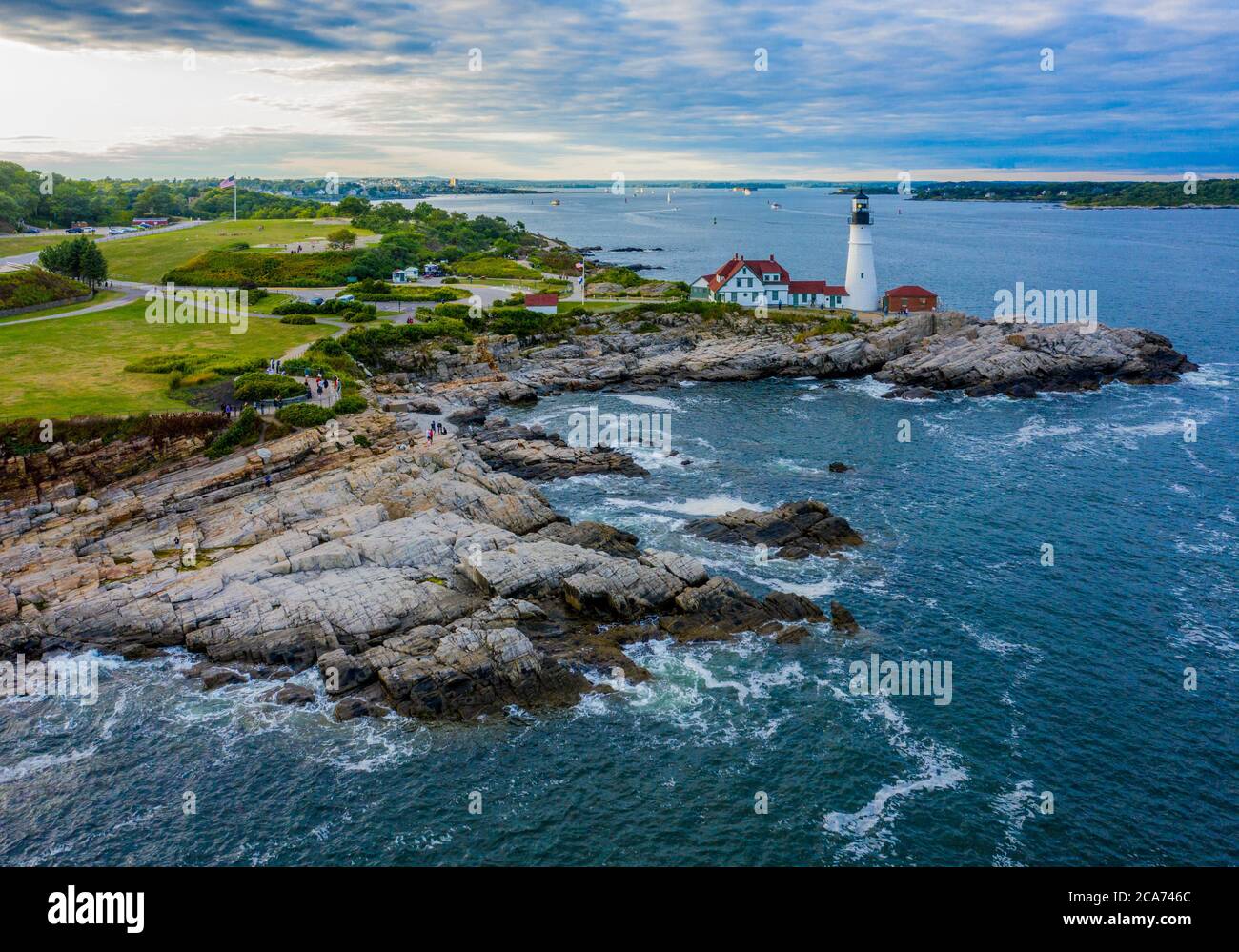 Aerial view of Portland Head Lighthouse in Maine as the sun begins to set over the east coast of