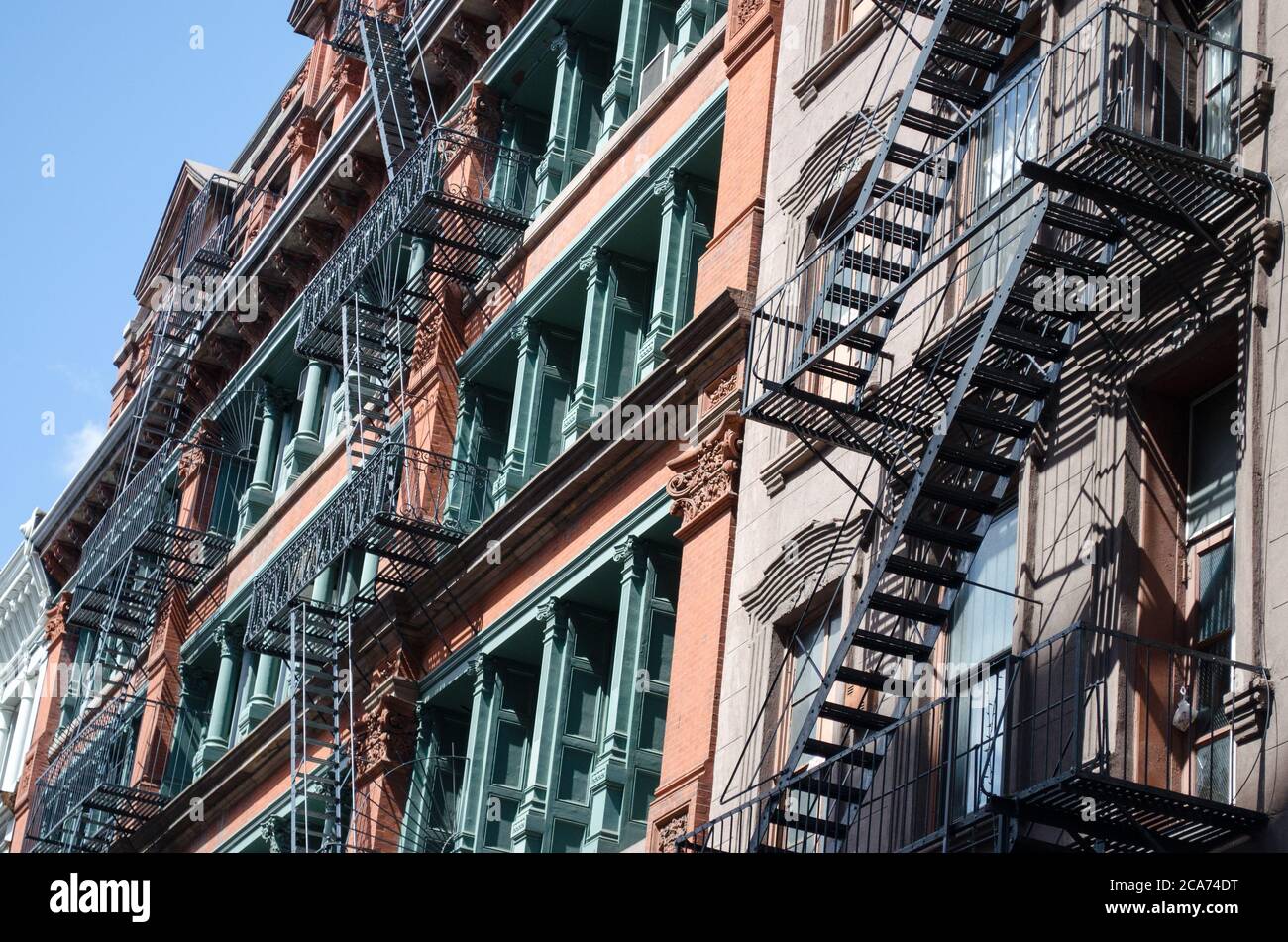 Modern and elegant New York Walk-up apartment building with eclectic fire-escapes Stock Photo