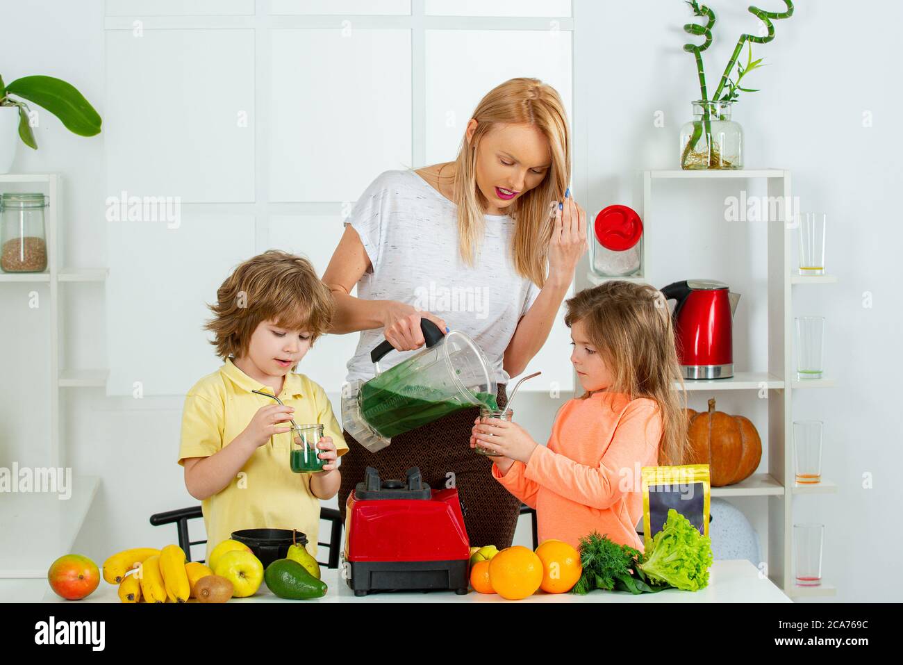 Raw, vegan, vegetarian, alkaline food concept. Mother and children