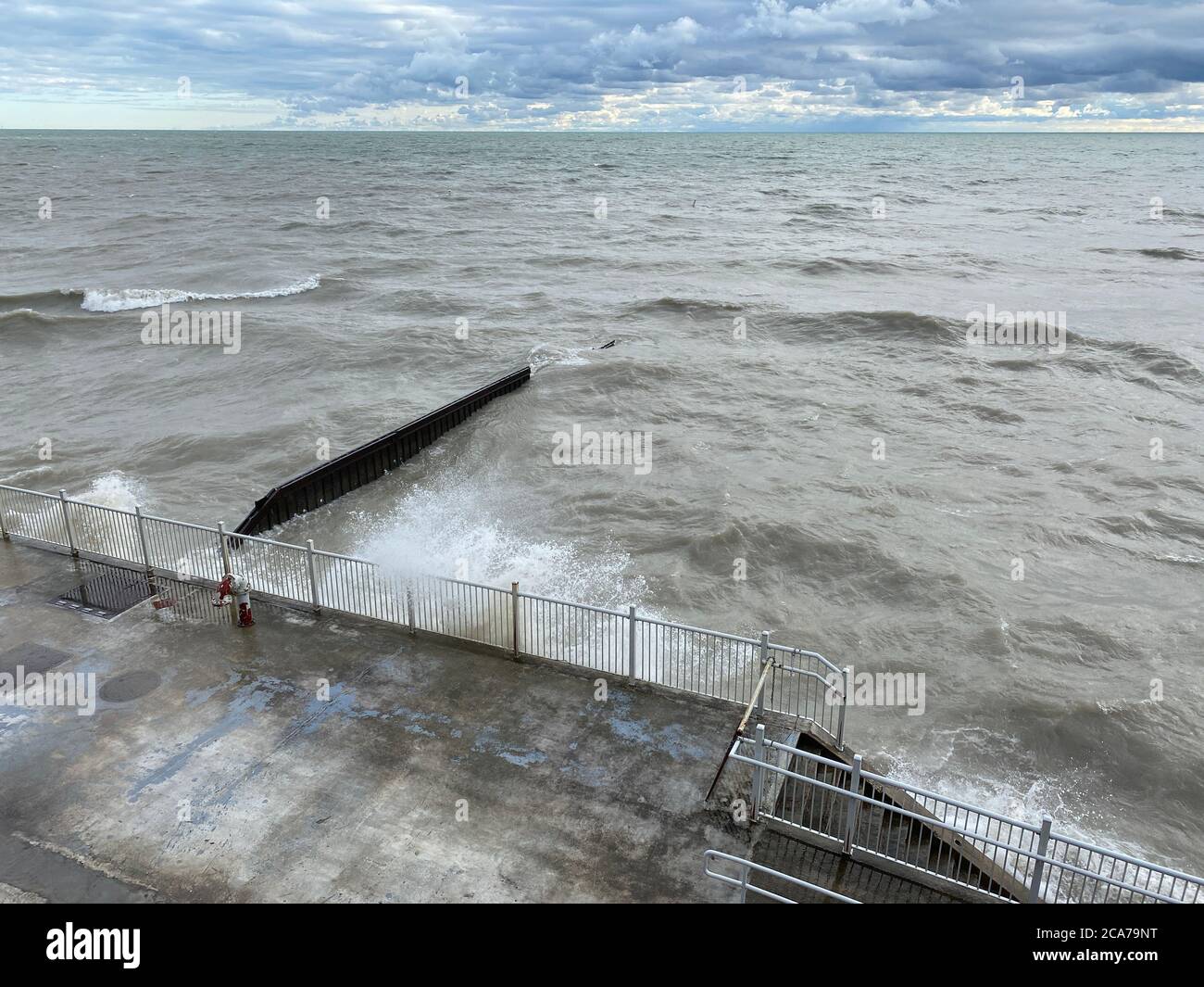 Wind advisory on Lake Michigan brings high waves to the Illinois shore on a summer day Stock Photo