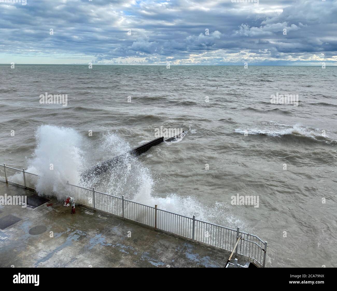 Wind advisory on Lake Michigan brings high waves to the Illinois shore on a summer day Stock Photo