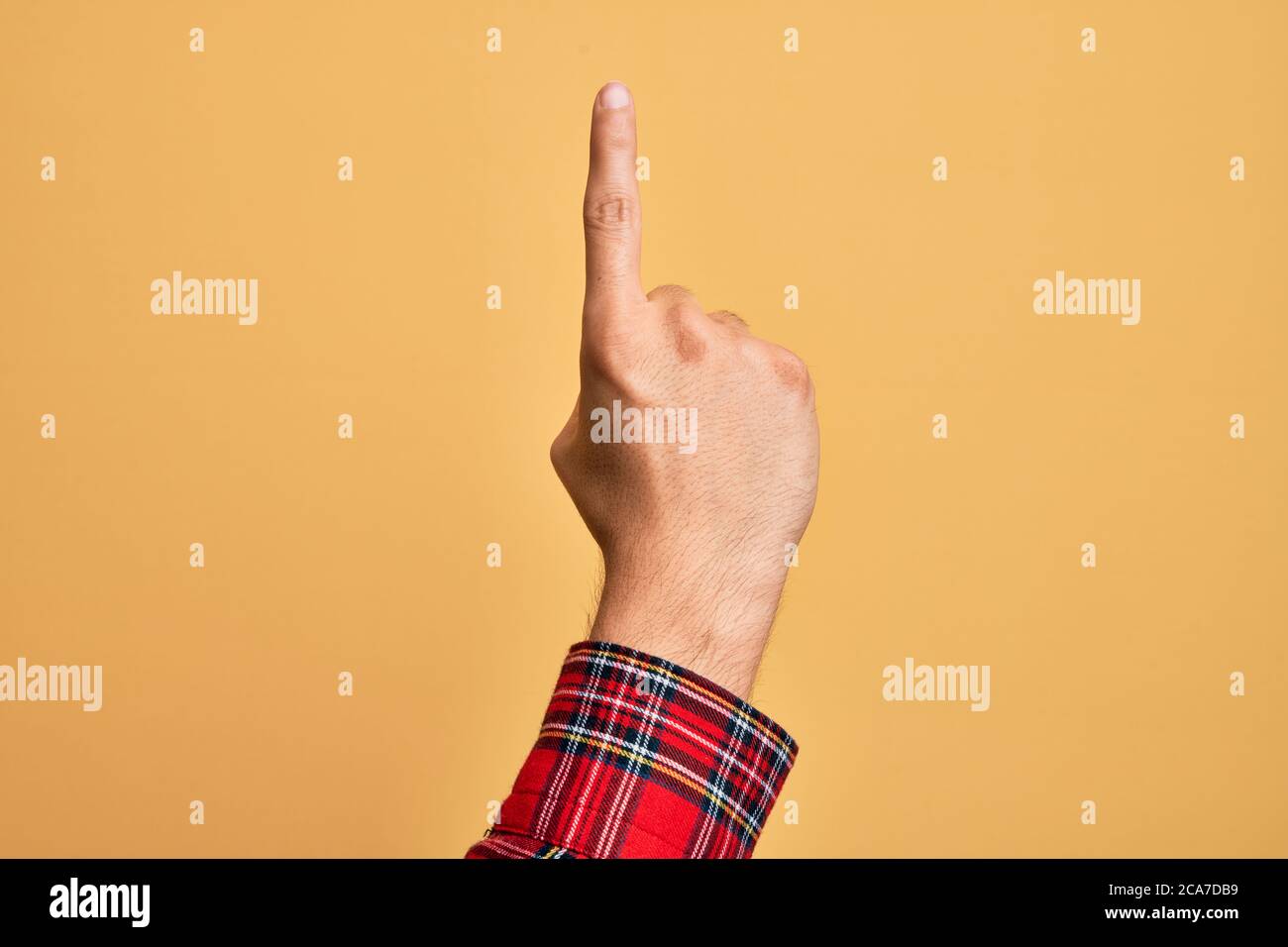 Hand of caucasian young man showing fingers over isolated yellow ...