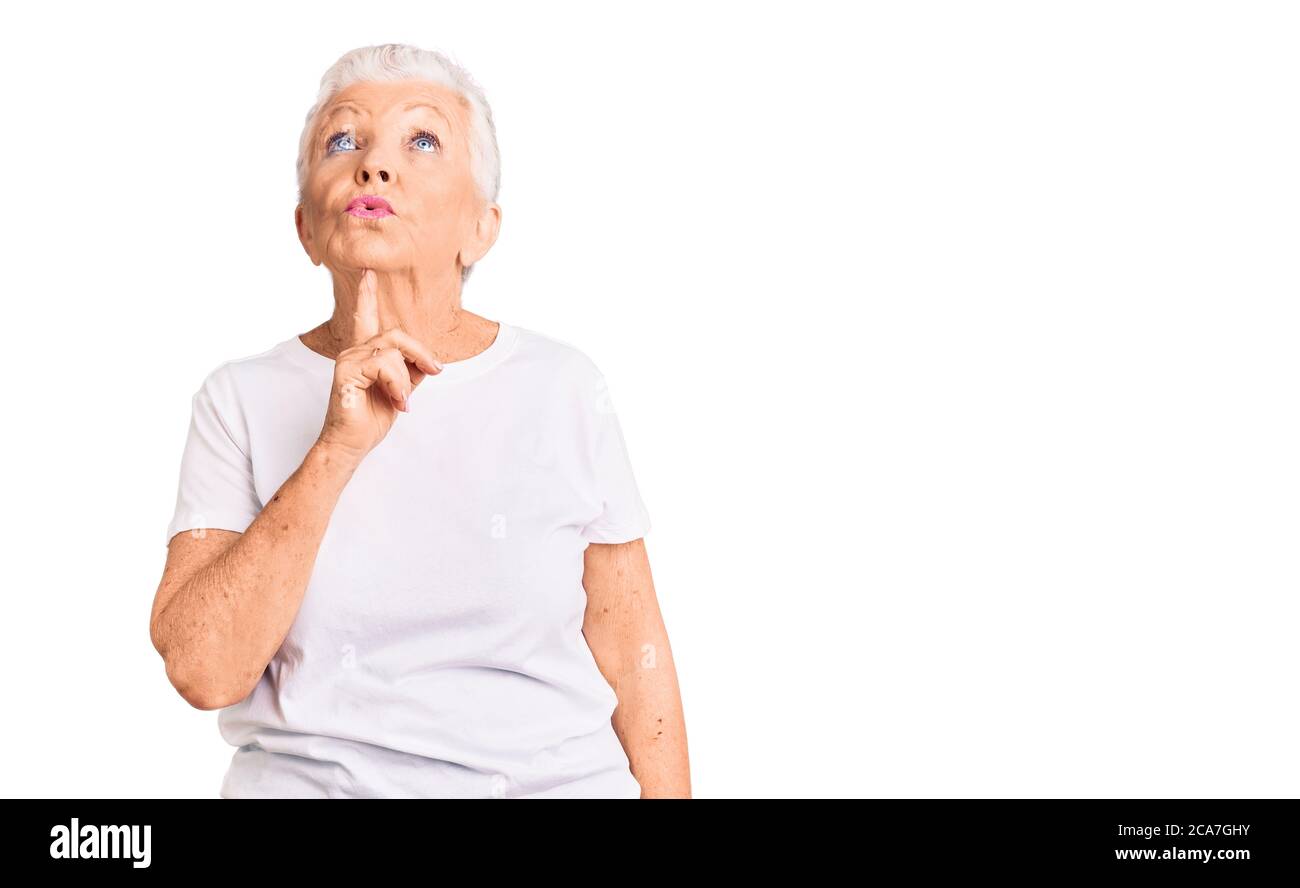 Woman eyes up finger on chin hi-res stock photography and images - Alamy