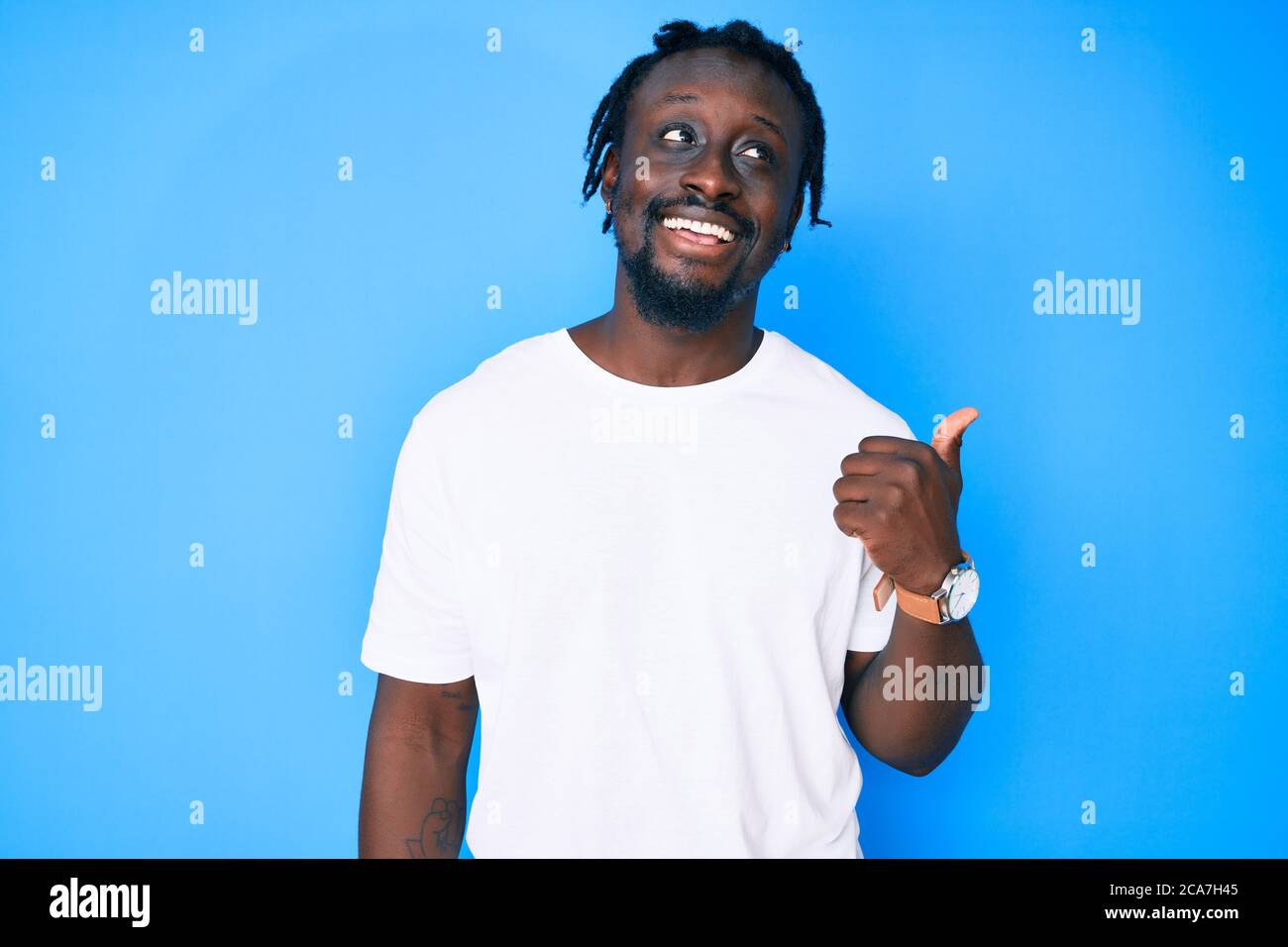 Young african american man with braids wearing casual white tshirt ...