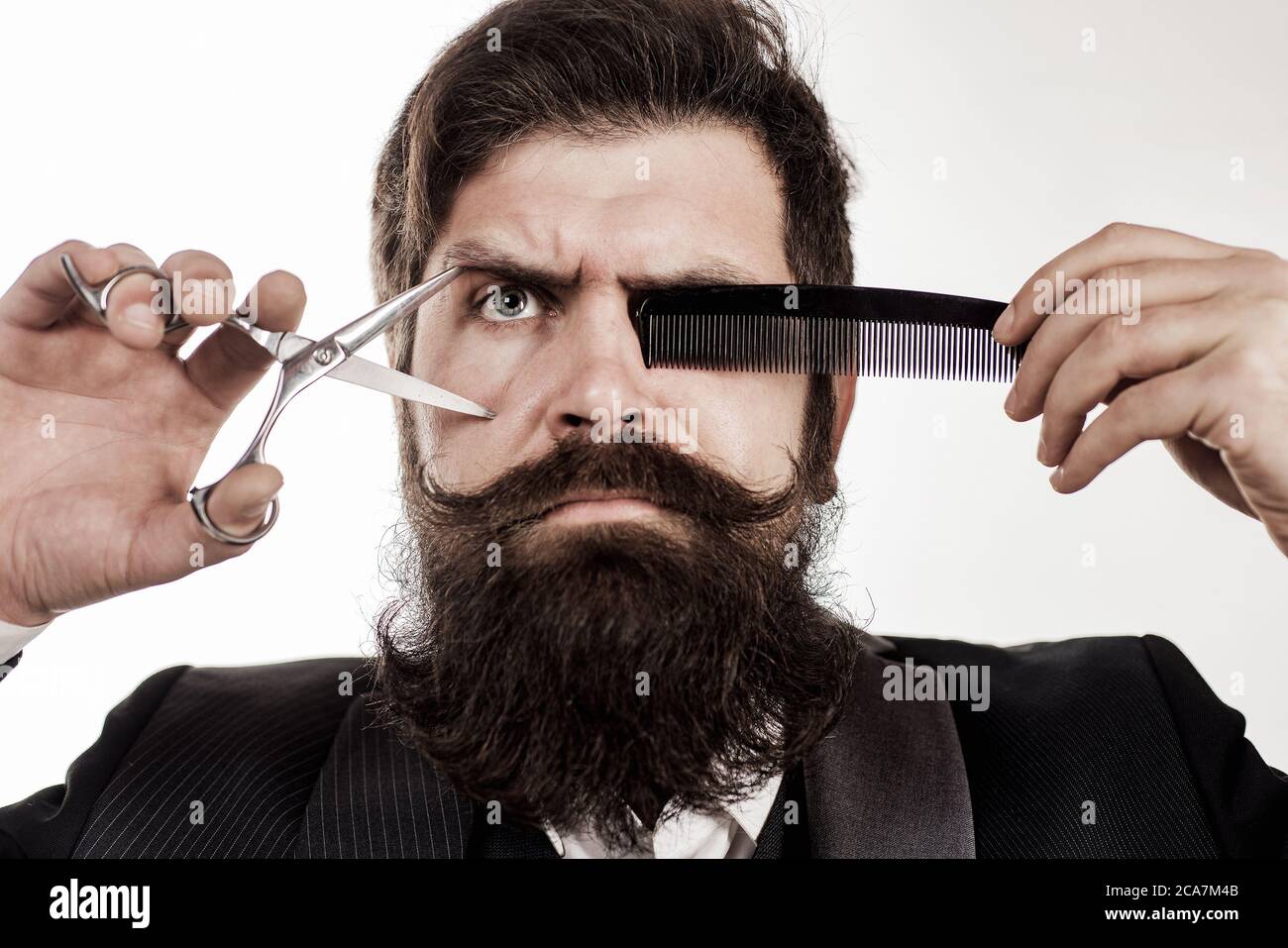 Bearded man with long beard and moustache. Barber in with