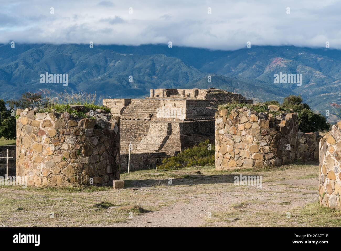 Round stone pillars on the North Platform of the pre-Columbian Zapotec ruins of Monte Alban in Oaxaca, Mexico.  A UNESCO World Heritage Site.  The pyr Stock Photo
