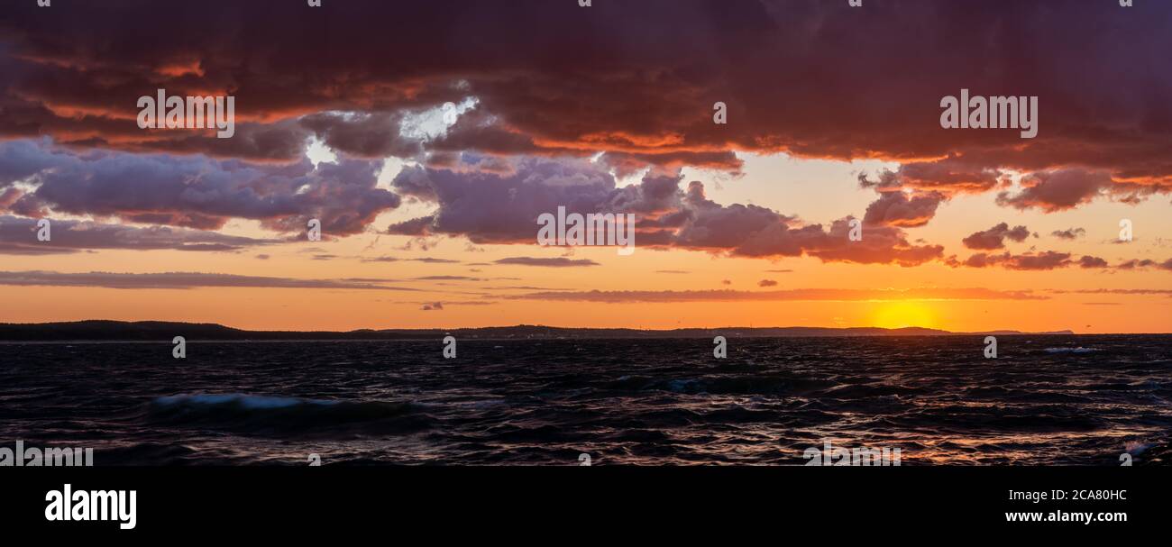 dramatic sunset over the stormy sea Stock Photo