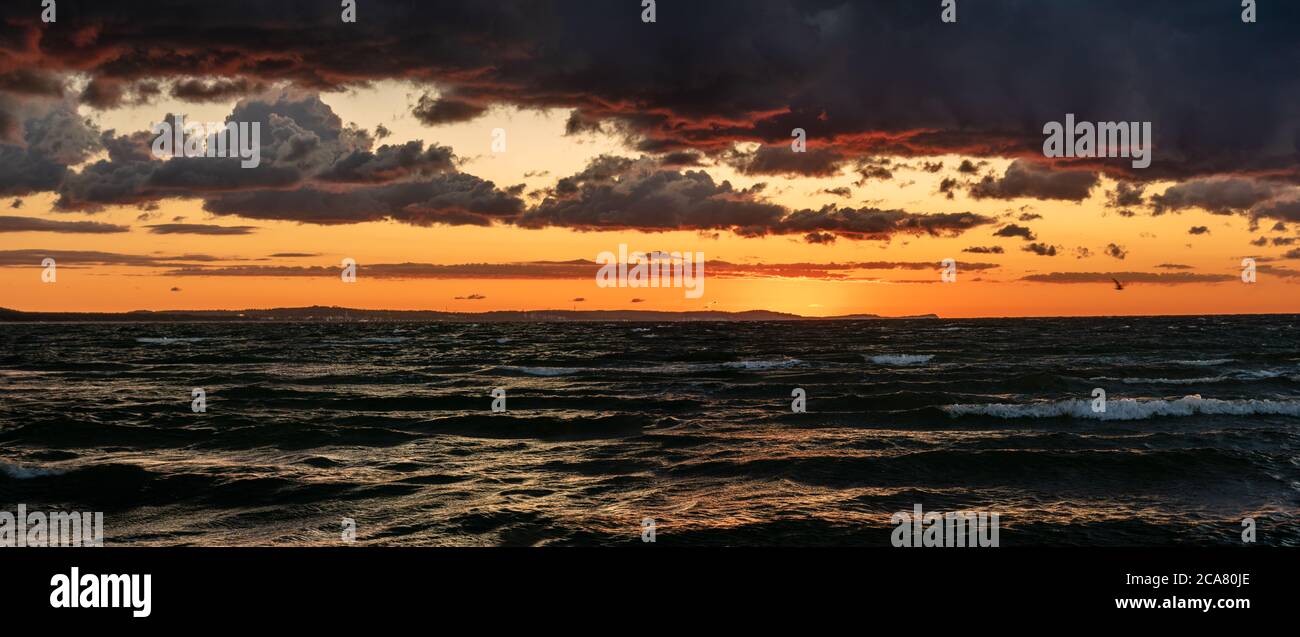 dramatic sunset over the stormy sea Stock Photo