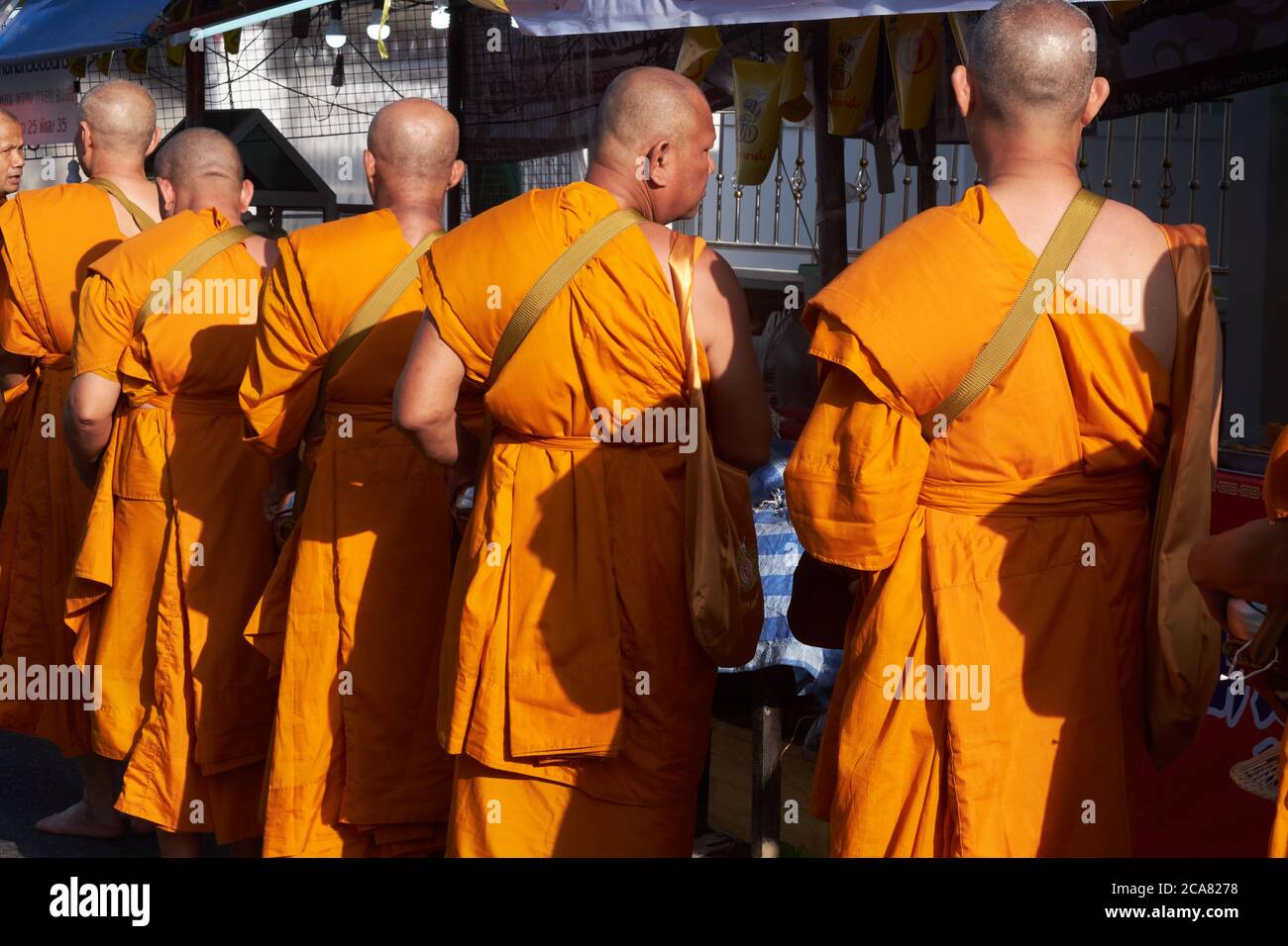 A group of Buddhist monks during their traditional morning alms round (binta baat) in Phuket Town, Thailand Stock Photo