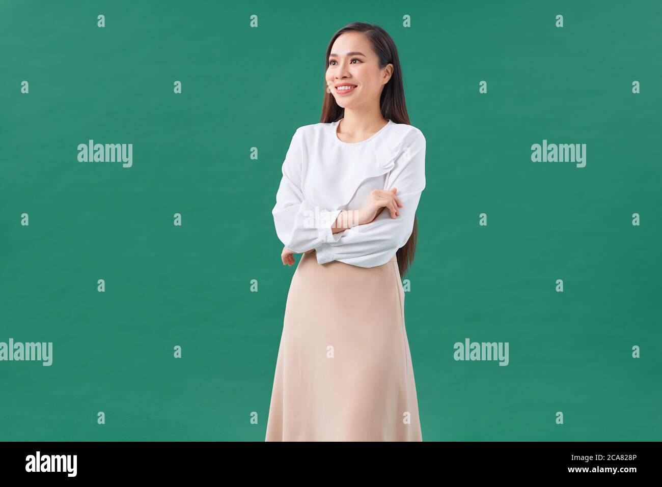 Portrait of young business woman smiling and looking at camera isolated ...