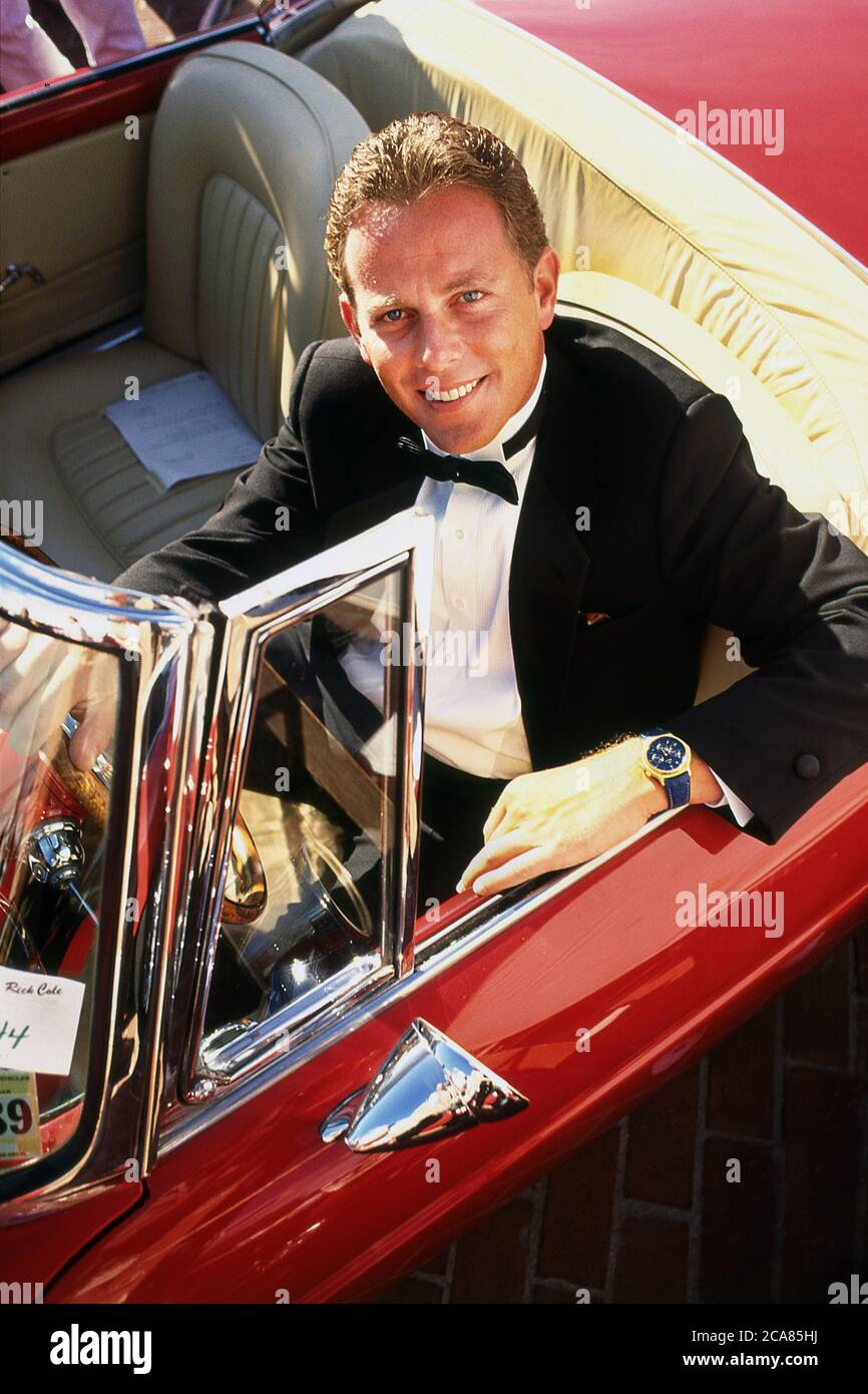 Rick Cole in one of the car for sale at the 1990 Rick Cole classic car auction in Monterey California USA Stock Photo