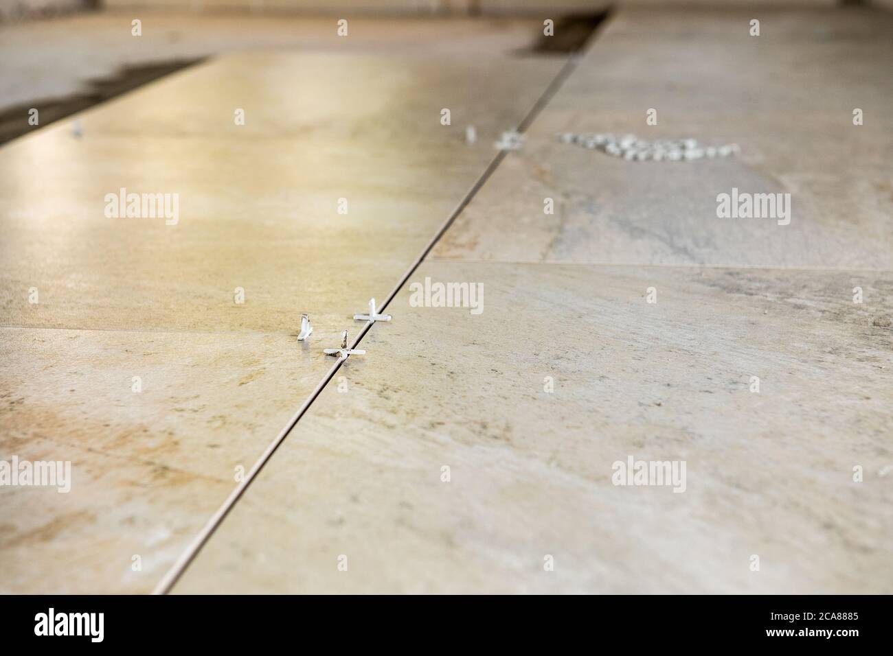 multiple tile spacers in place on freshly installed new luxury tiles on