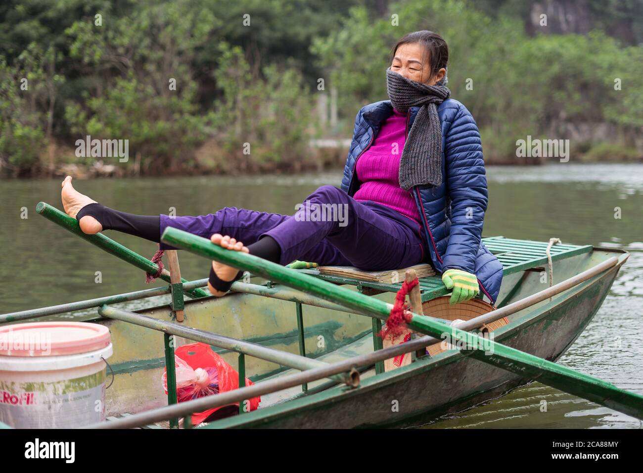 Tam Coc / Vietnam January 25, 2020 Vietnamese woman rowing boat with