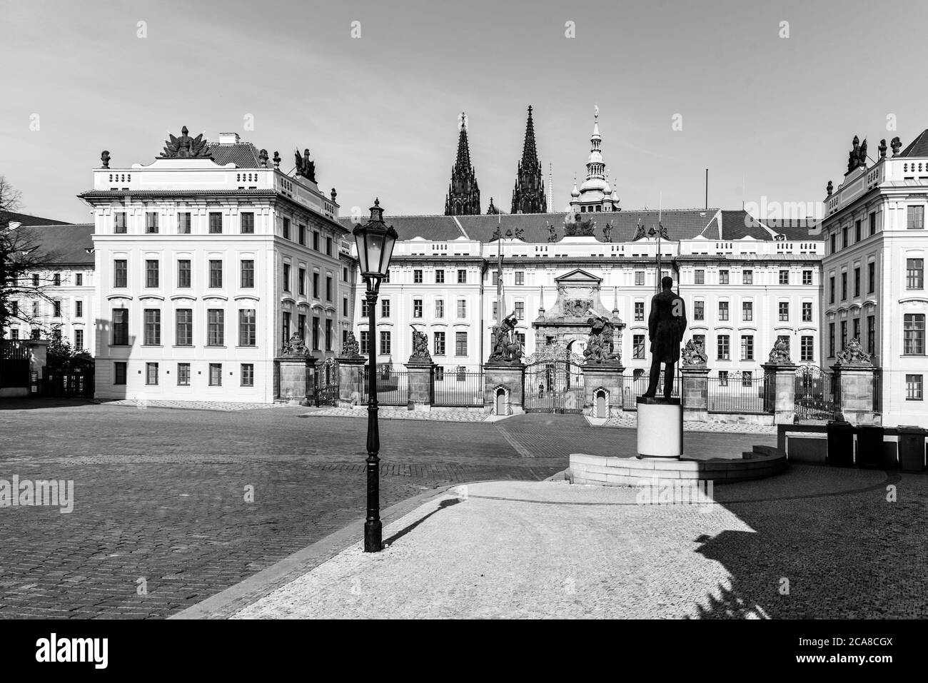 Hradcany square with entrance gate to Prague Castle and statue of Tomas Garrigue Masaryk - the first President of Czechoslovakia, Praha, Czech Republic. Black and white image. Stock Photo