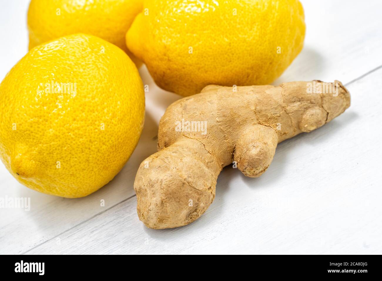 lemons and ginger root on white wooden background Stock Photo