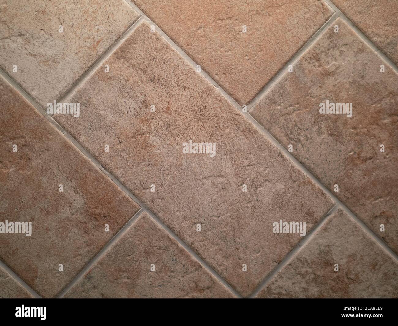 closeup of terracotta flooring after restoration, with rectangular tiles Stock Photo