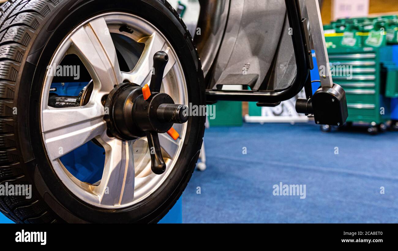 A car wheel on an automated car wheel balance machine in the garage ...