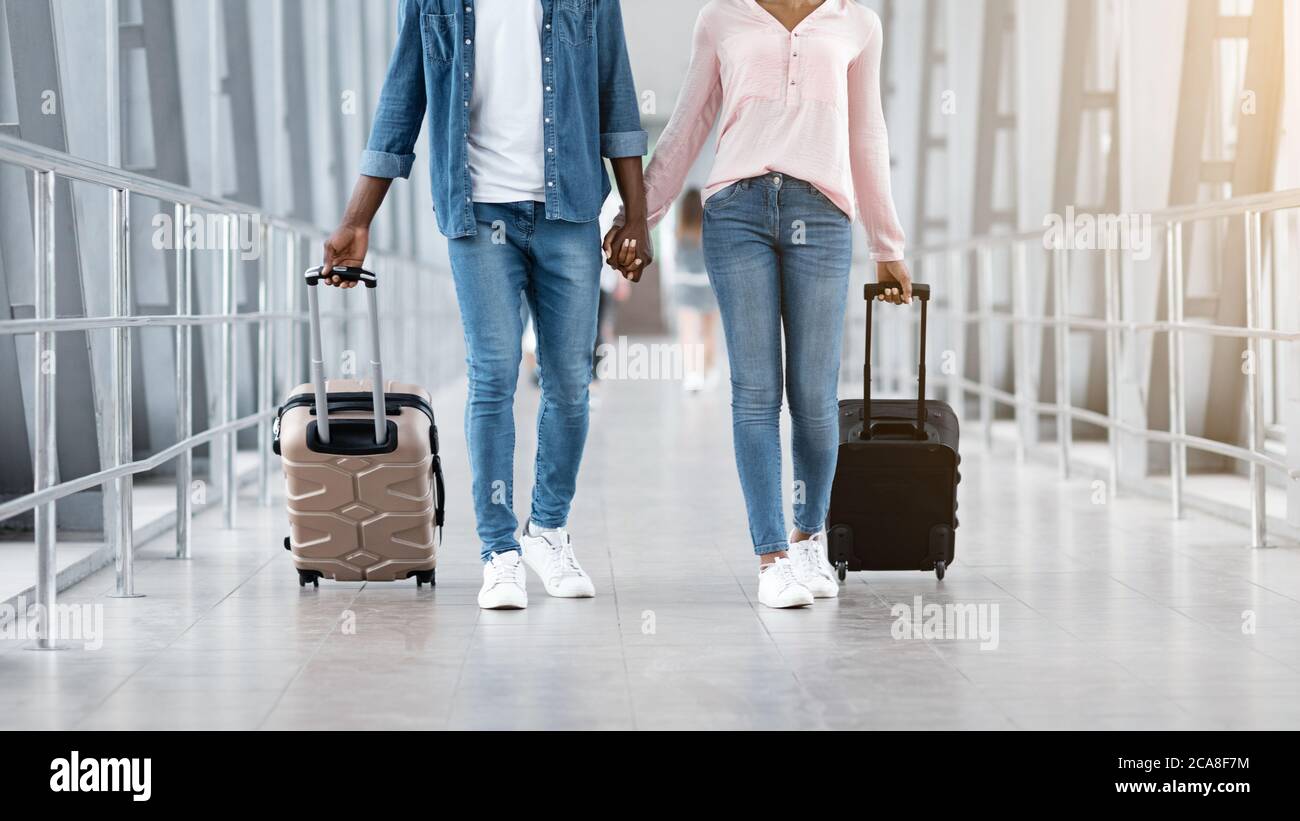 Travelling Together. Black Couple Walking With Suitcases At Airport ...