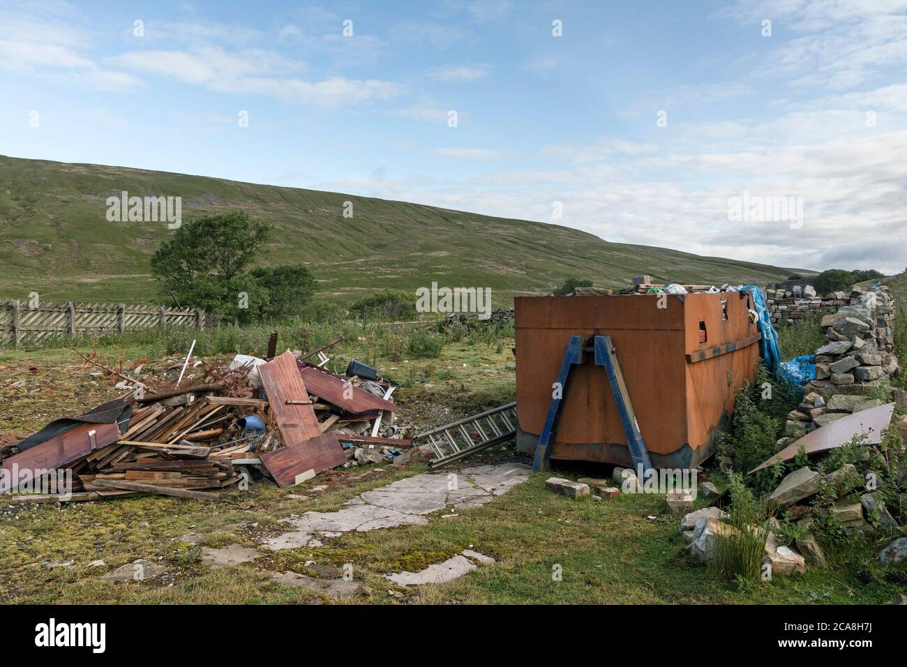 Overflowing Skip and Rubbish Strewn Around Next to the Blea Moor Signal Box Railway House, Yorkshire Dales, National Park, Yorkshire, England, UK, Stock Photo