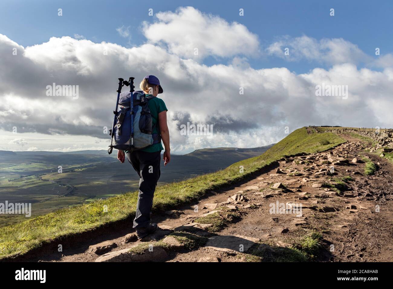 Walker Heading along the Summit Ridge of Whernside from Knoutberry Hill, Yorkshire Dales, UK Stock Photo