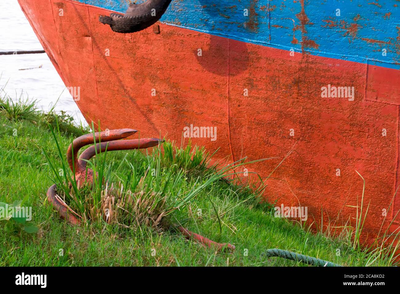 Old rusty pirate ship anchor laying on the ground Stock Photo Alamy