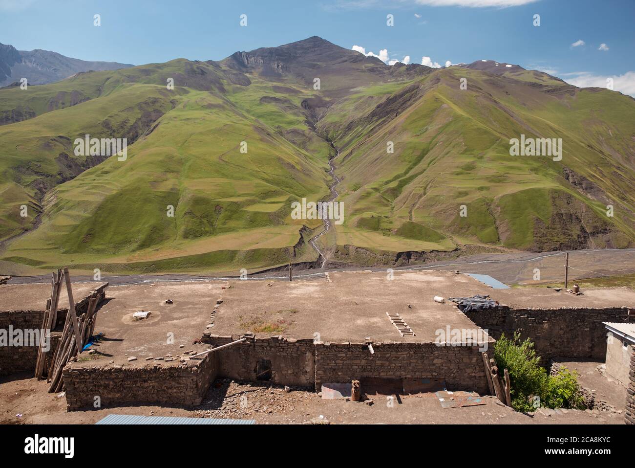 Xinaliq / Azerbaijan - July 8, 2019: scenic view of mountain village with beautiful Caucasus mountains in the background Stock Photo