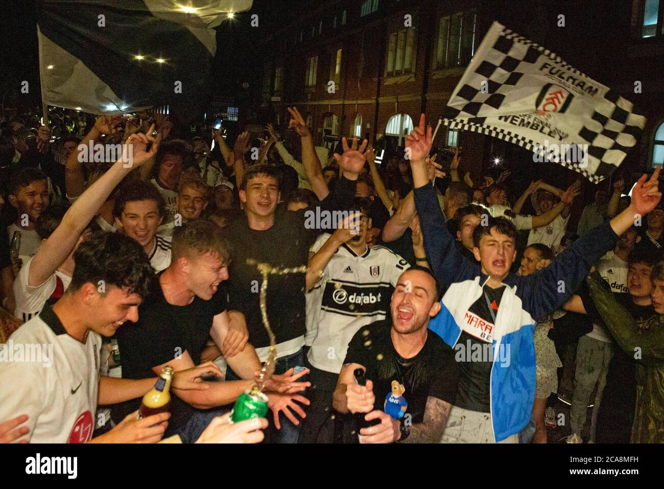 Fulham F.C. fans celebrate their team beating local rivals Brentford F.C.to secure promotion into the Premier League on the 4th of August 2020 Stock Photo