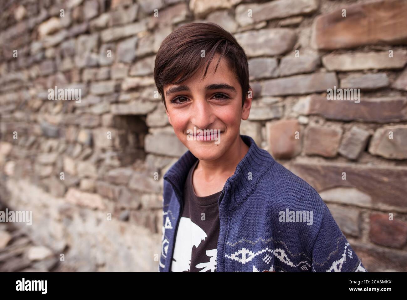 Xinaliq / Azerbaijan - July 8, 2019: portrait of boy on streets of stone houses village Stock Photo
