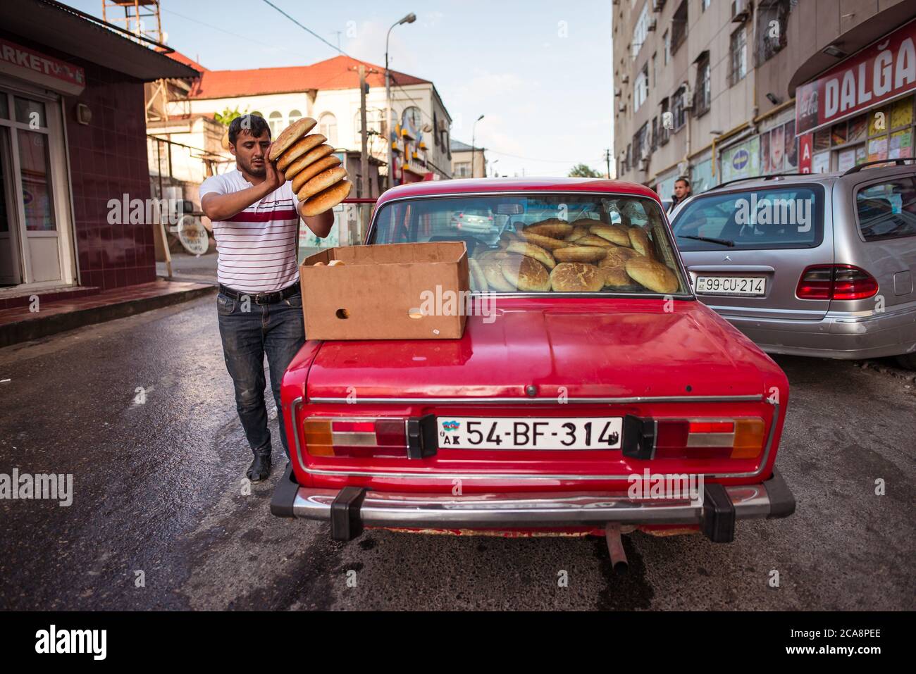 Baku / Azerbaijan - June 7, 2019: man transporting bread in a red lada Stock Photo