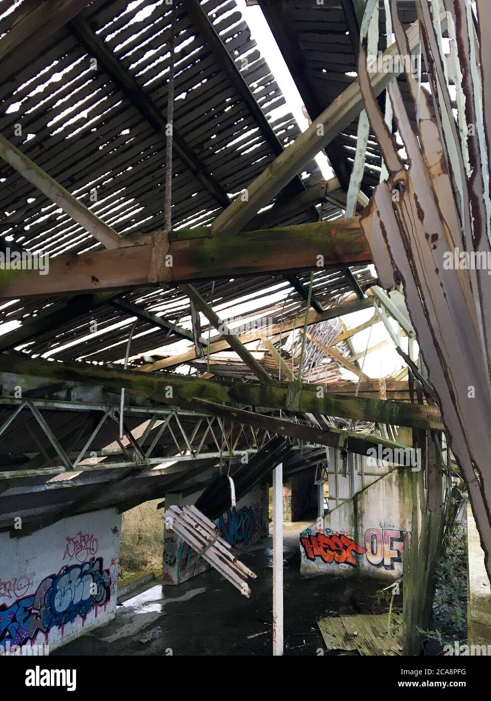 Collapsing roof of an abandoned building. Stock Photo