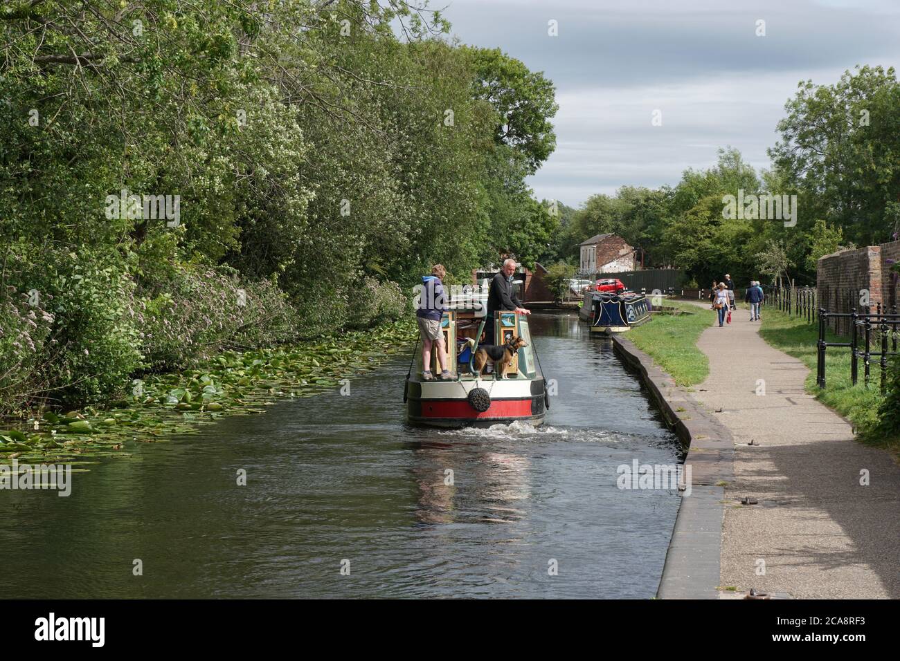 Barge cruising on the Stourbridge Canal near the Bonded Warehouse. West Midlands, Black Country. England. UK Stock Photo