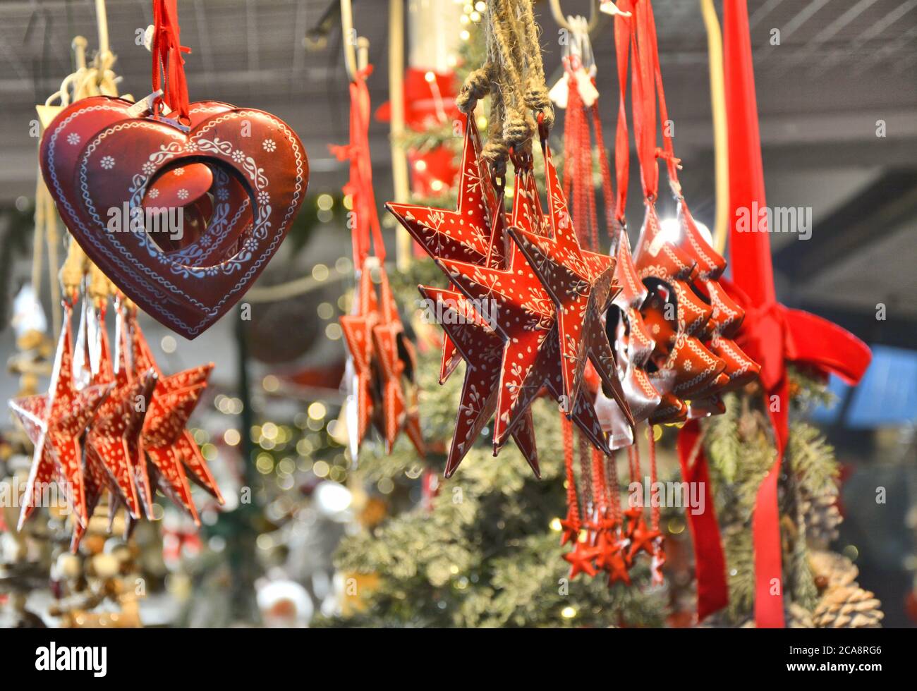 Christmas beautiful hanging ornaments on Christmas market stall. Stock Photo