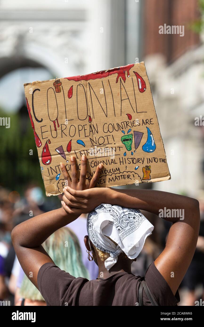 Rear view of a protester holding a sign abover her head during a Black Lives Matter demonstration, Marble Arch, London, 2 August 2020 Stock Photo