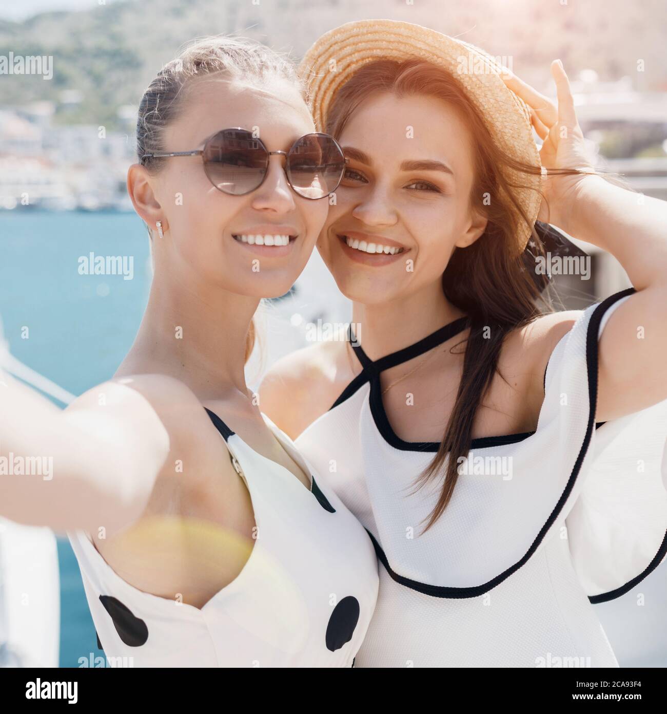 Two beautiful young smiling woman doing selfie Stock Photo - Alamy