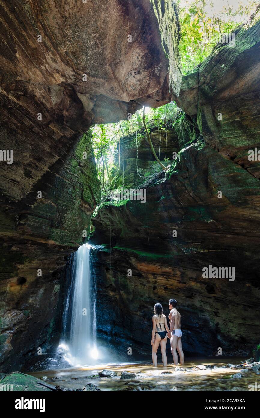 Backpackers enjoying a pristine waterfall and mountain stream in the heart of the South American rainforest, Minas Gerais, Brazil, South America Stock Photo
