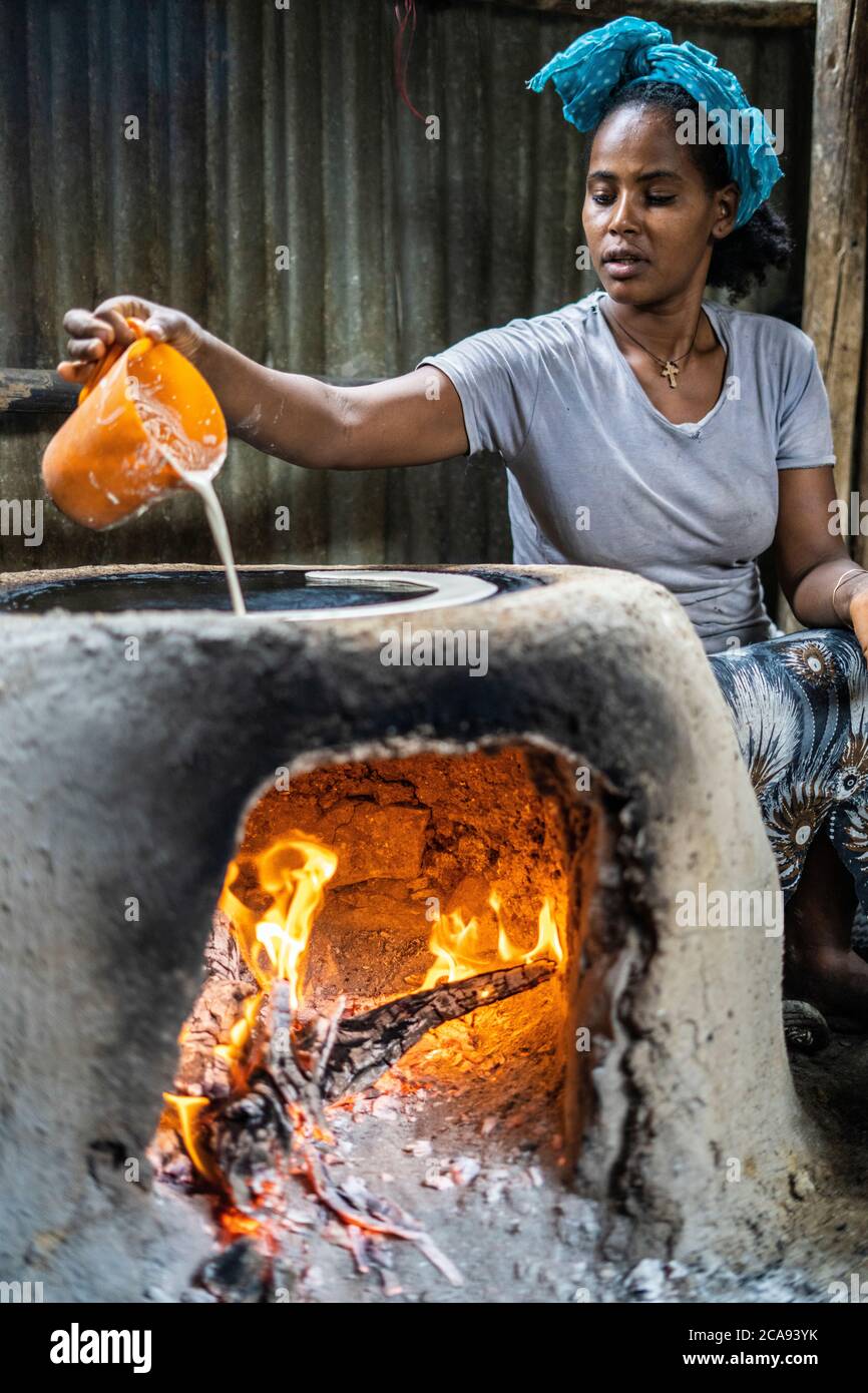 Woman making injera bread on traditional oven, Berhale, Afar Region, Ethiopia, Africa Stock