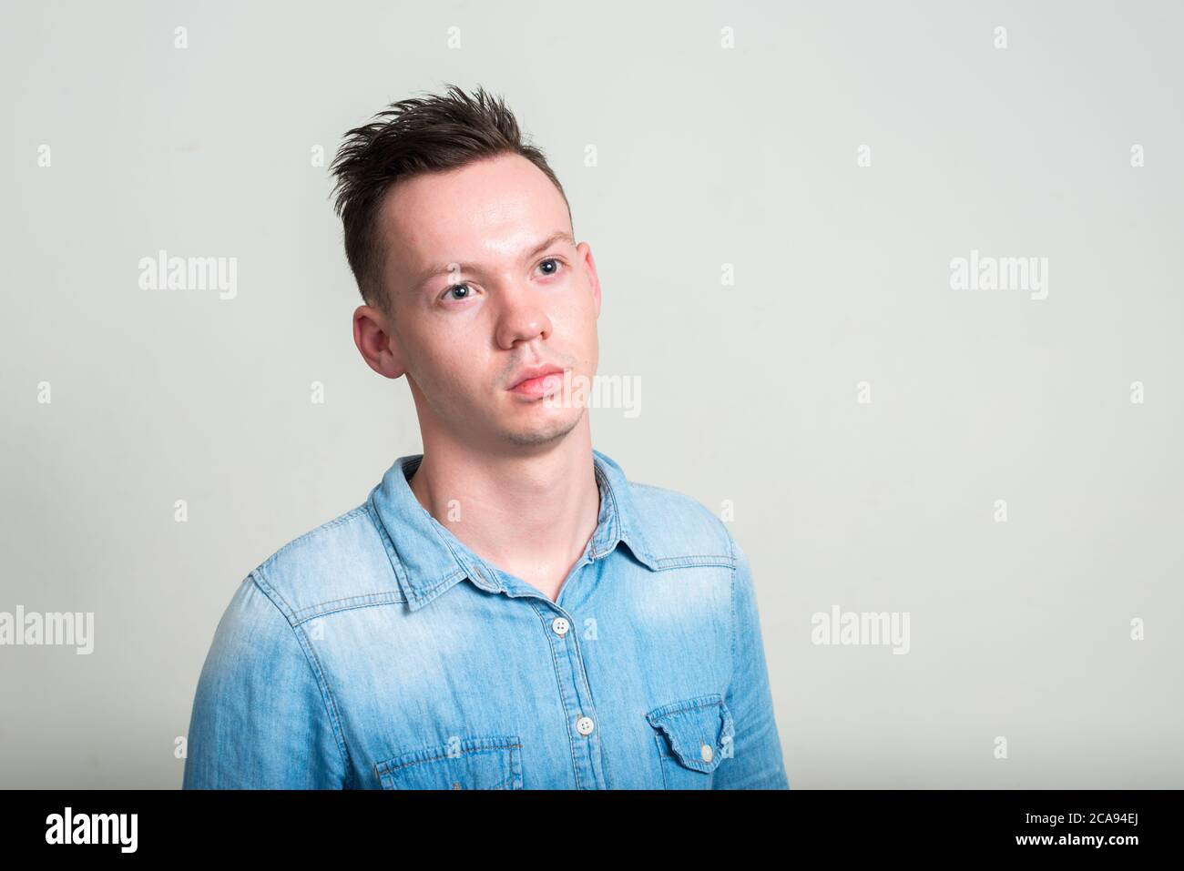 Portrait of young man against white background Stock Photo - Alamy