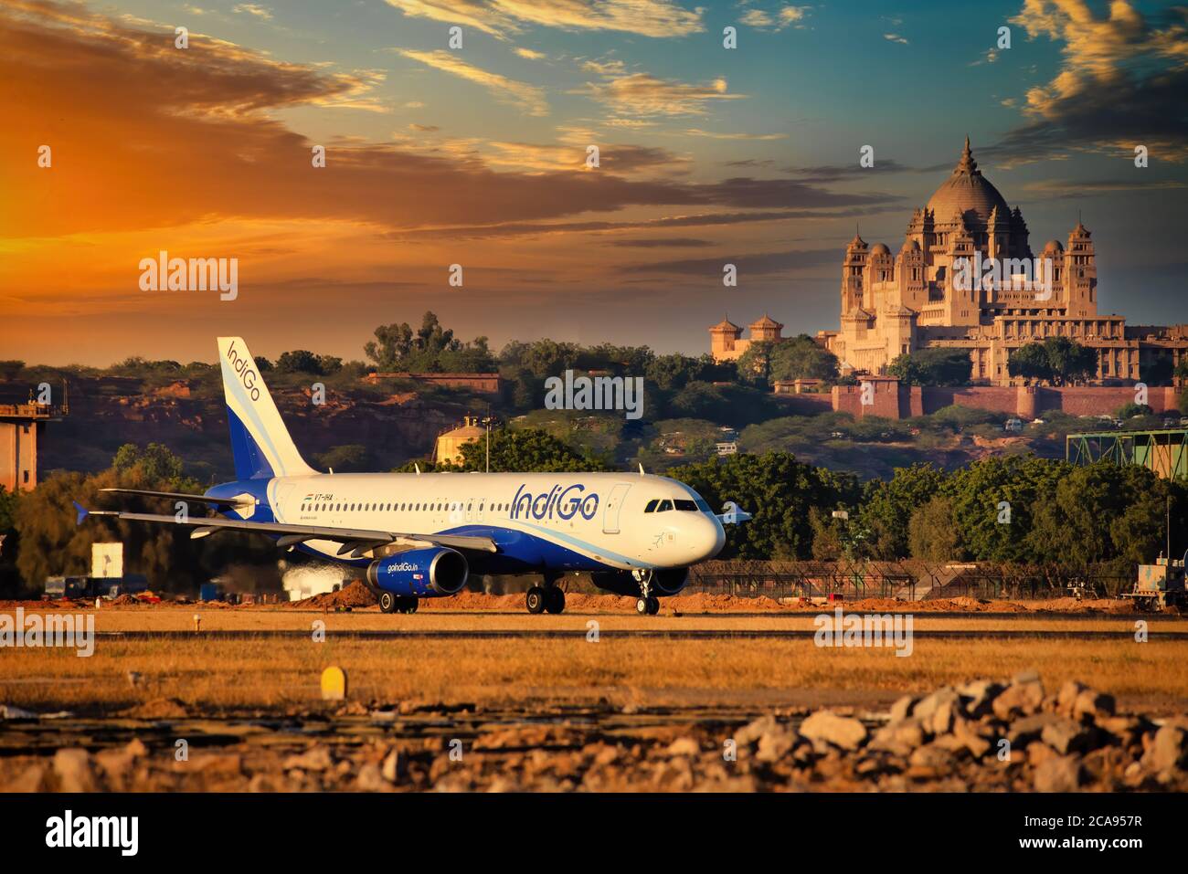 Indigo Airlines, Indian low cost carrier rolling out,Jodhpur Airport with the famous Umaid Bhawan Palace in background, Rajasthan, India, Asia Stock Photo