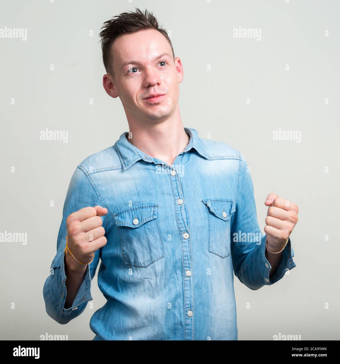 Portrait of young man against white background Stock Photo - Alamy