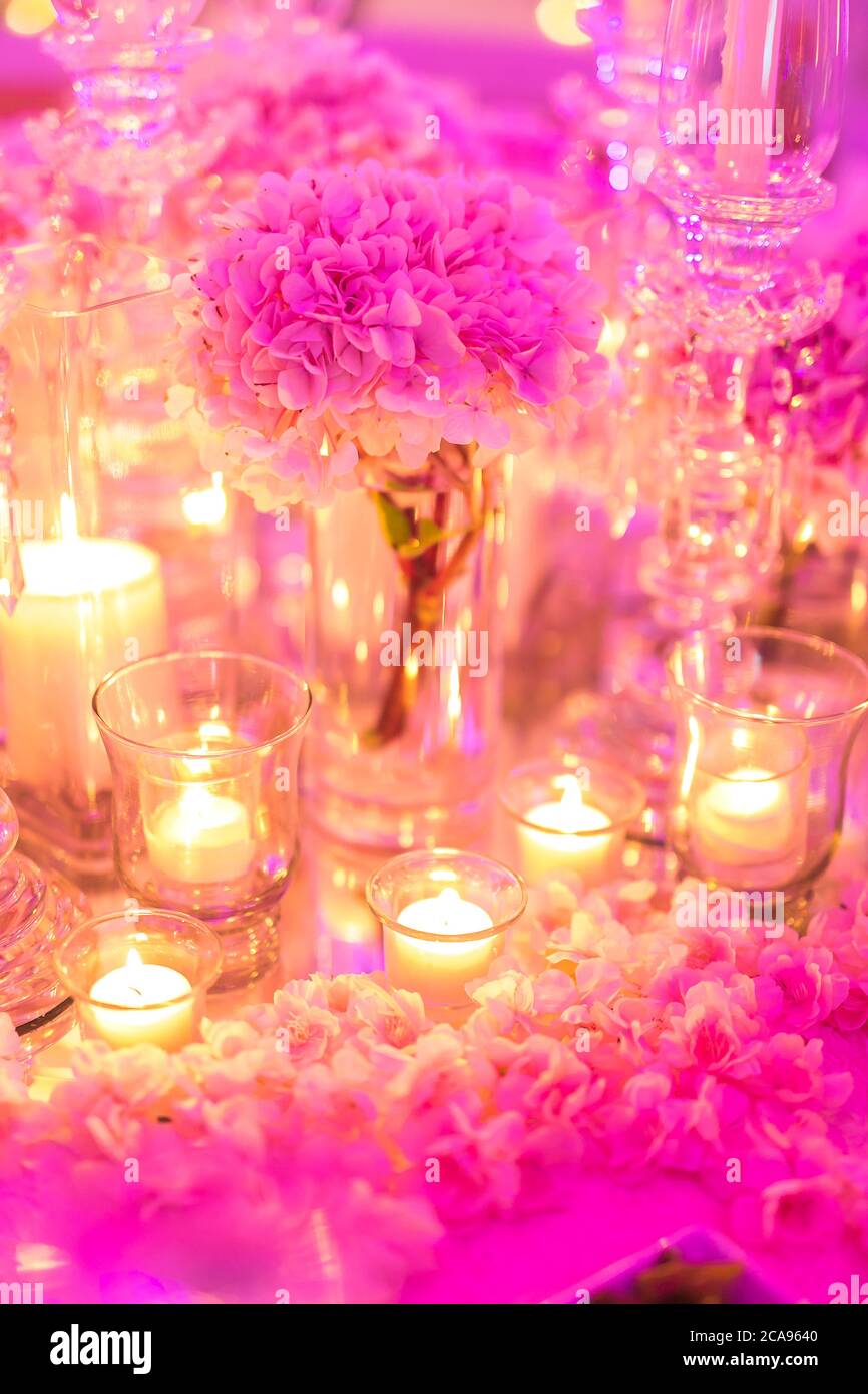 Focus On The Candle Decoration With Pink Flowers On The Table During A Wedding Ceremony Stock Photo Alamy