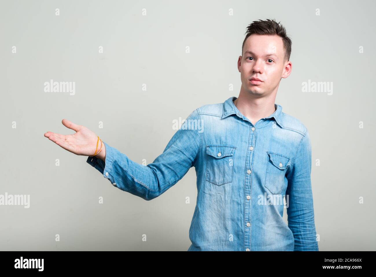 Portrait of young man against white background Stock Photo - Alamy