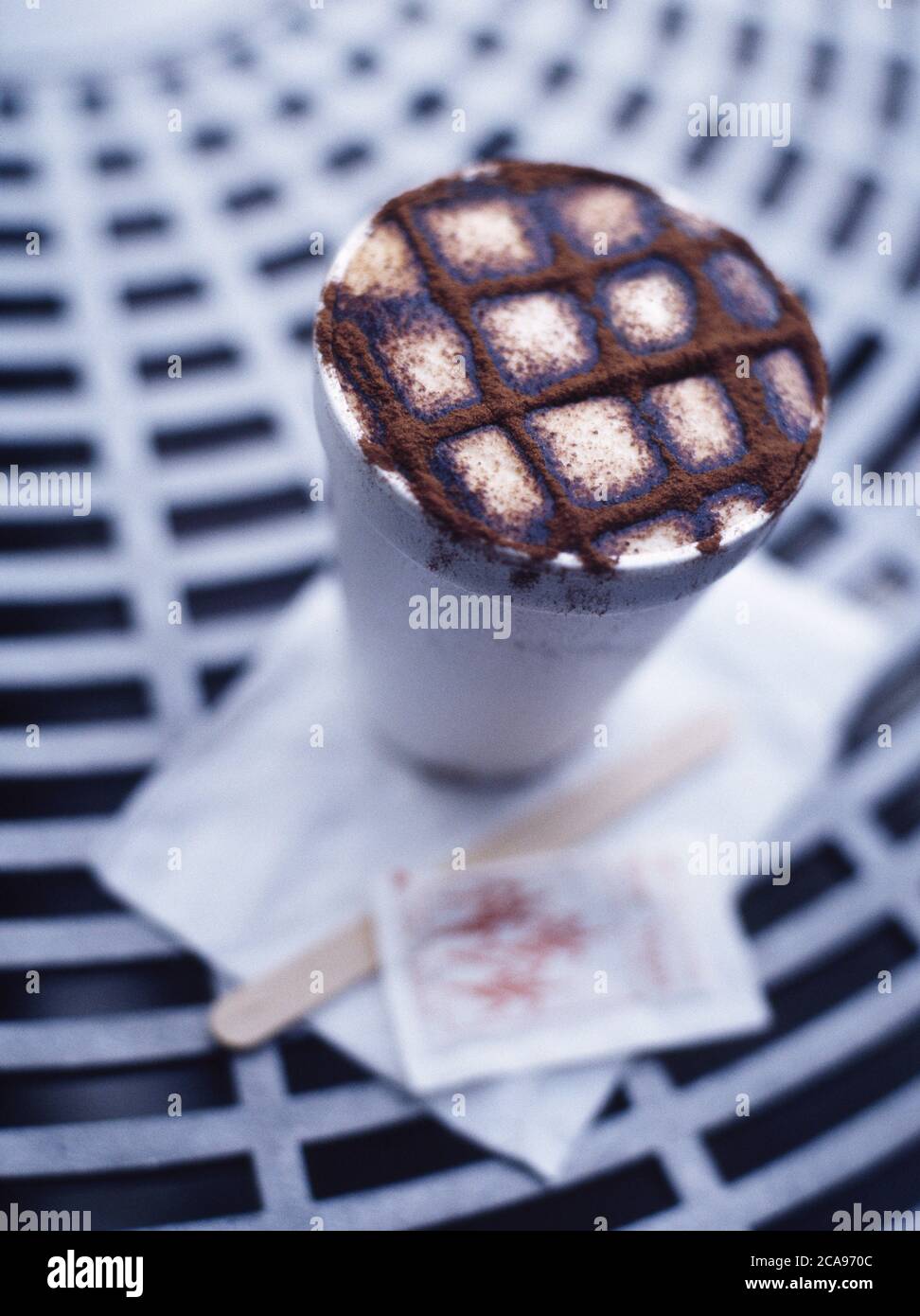 Take away cup of coffee cappuccino with checkered chocolate sprinkles